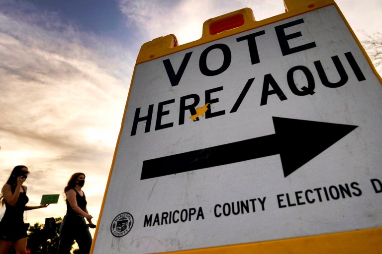 Voters deliver their ballots to a polling station.