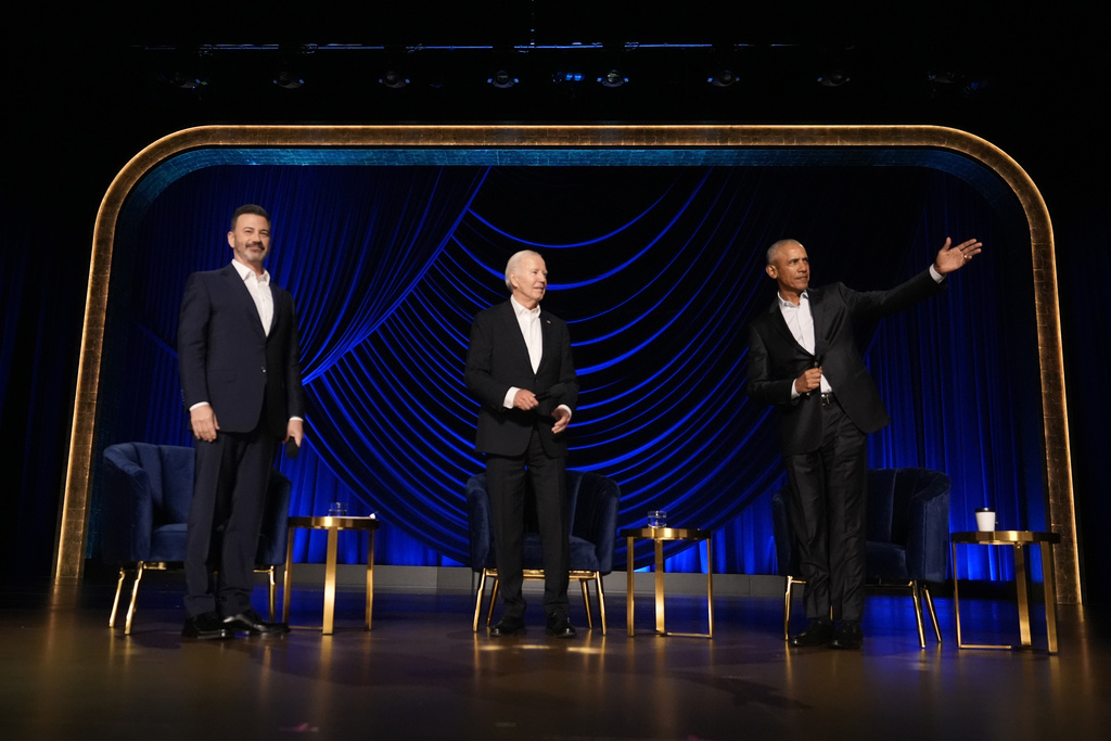 President Joe Biden looks as former President Barack Obama gestures during a campaign event moderated by Jimmy Kimmel