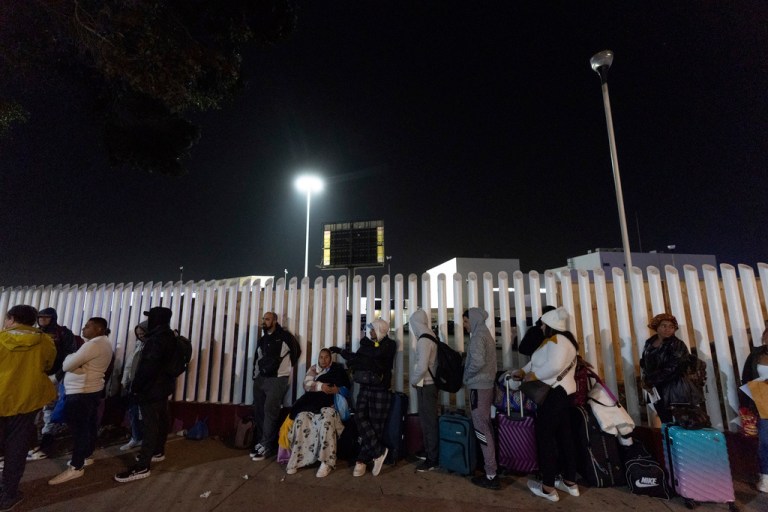 Migrants from Cuba and Venezuela line up at a Mexican immigration checkpoint.