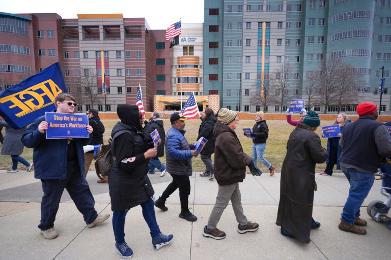 Current and former federal workers and members of the American Federation of Government Employees (AFGE) protest outside the John D. Dingell Veterans Affairs Medical Center in Detroit, Friday, Feb. 28, 2025.