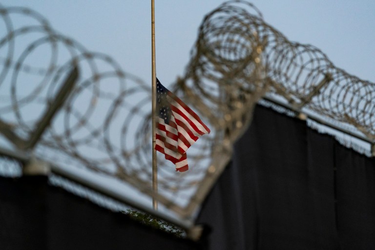 An American flag flies half-staff at Guantanamo Bay.