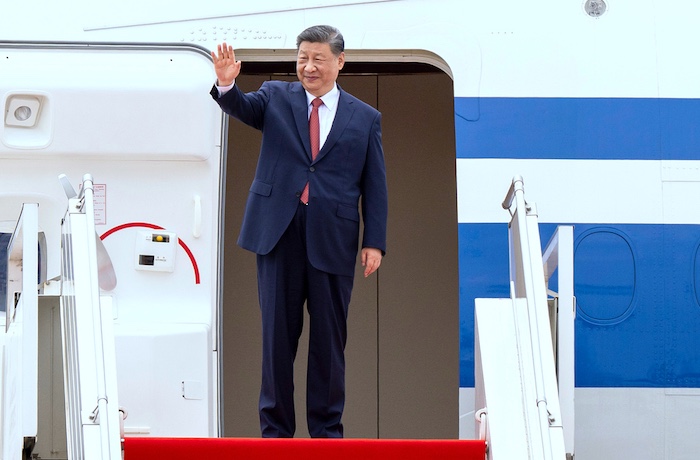 In this photo released by Agence Kampuchea Press (AKP), Chinese President Xi Jingping waves from a plane during a send-off ceremony at Phnom Penh International Airport in Phnom Penh, Cambodia, Friday, April 18, 2025.