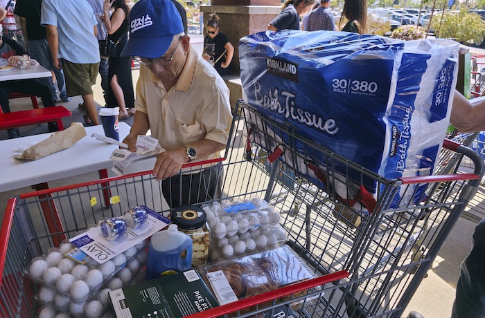 A customer checks his shopping receipts.