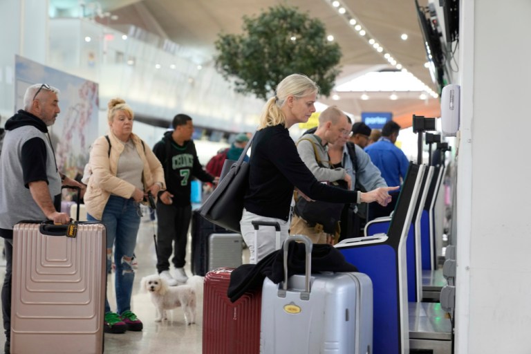 Travelers check into their flights at Newark Liberty International Airport.