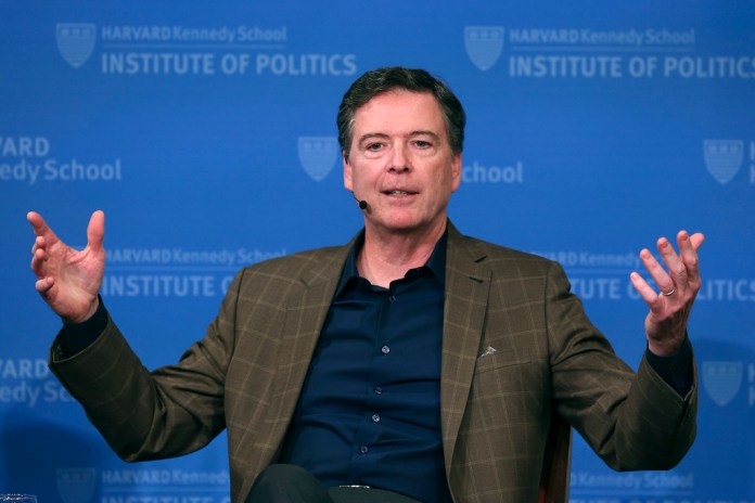 FILE - Former FBI director James Comey gestures while speaking at Harvard University's Institute of Politics' JFK Jr. Forum in Cambridge, Mass., Feb. 24, 2020.