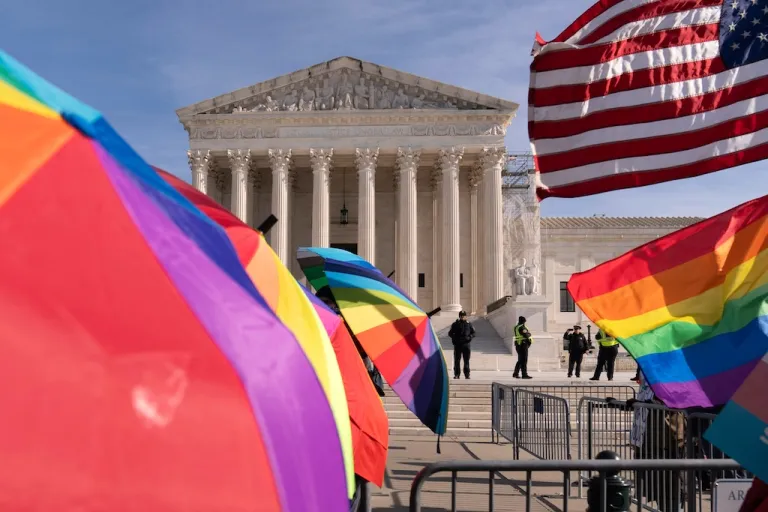 Transgender rights supporters rally outside of the Supreme Court.
