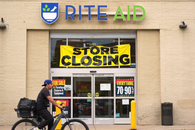 A Rite Aid store with a closing sign.