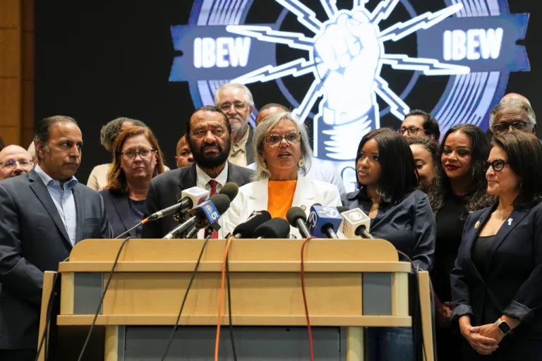Rep. Robin Kelly, D-Ill., center, surrounded by other Democratic members of Congress and Texas House Democrats, speaks during a press conference at the Democratic Party in Warrenville, Ill., Monday, Aug. 4, 2025. (AP Photo/Nam Y. Huh)