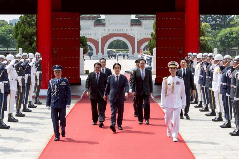 In this photo released by the Taiwan Presidential Office, Taiwan's President Lai Ching-te, center, arrives for a ceremony for honoring soldiers and officials during Taiwan's Arm Forces Day on Wednesday, Sep. 3, 2025 in Taipei, Taiwan. (Taiwan Presidential Office via AP)