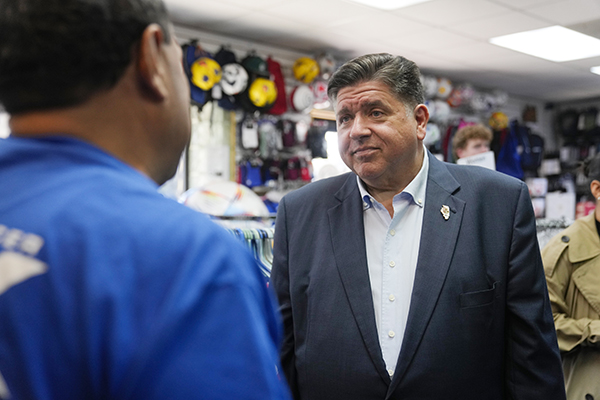 Illinois Gov. J.B. Pritzker, right, speaks with Leonel Tovar at his family's soccer gear business Extreme Soccer, Thursday, Sept. 4, 2025, in Berwyn, Ill. (AP Photo/Erin Hooley)
