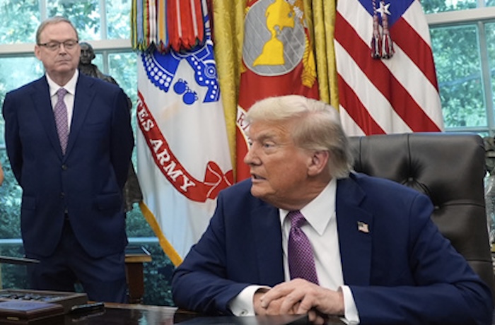President Donald Trump speaks in the Oval Office of the White House, Friday, Sept. 5, 2025, in Washington, as U.S. Chief of Protocol Monica Crowley and Director of the National Economic Council Kevin Hassett listen. (AP Photo/Alex Brandon)