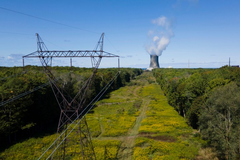 A nuclear power plant is seen in the distance.