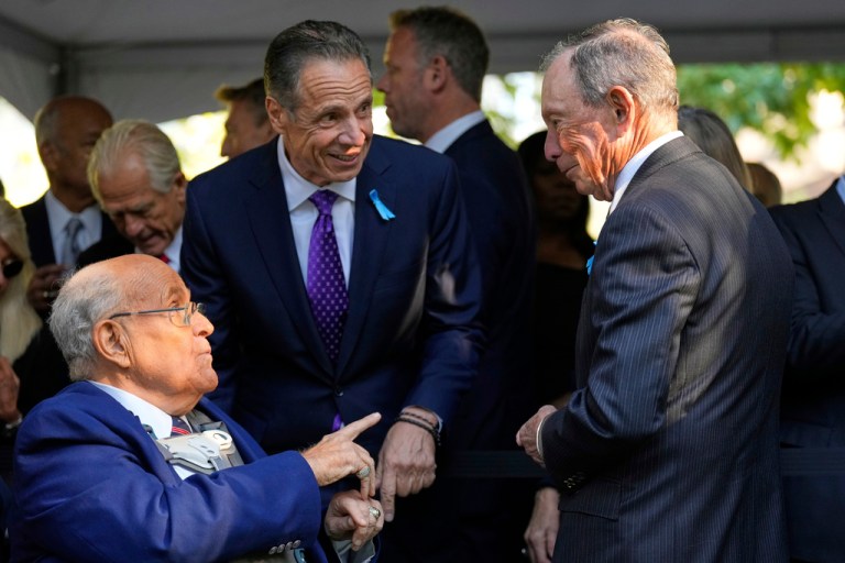 Former NYC mayors Rudy Giuliani, left, and Michael Bloomberg, right, talk with current mayoral candidate Andrew Cuomo during a ceremony to mark the 24th anniversary of the 9/11 attacks, Thursday, Sept. 11, 2025, in New York.
