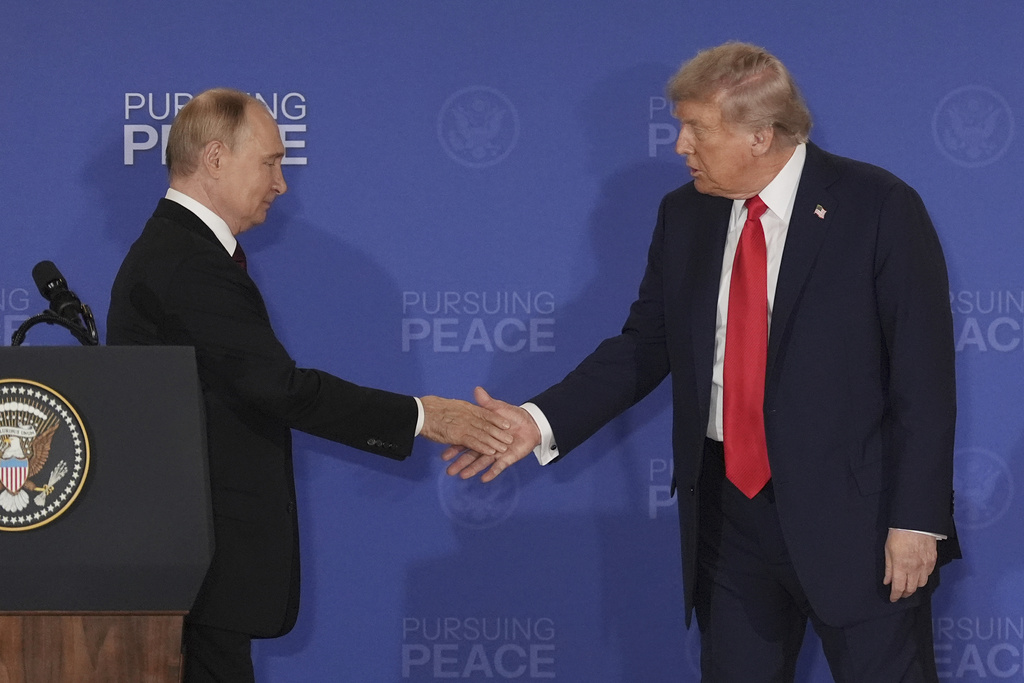 President Donald Trump shakes hands with Russian President Vladimir Putin.