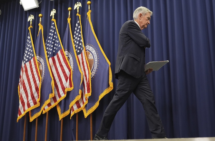 Federal Reserve Chairman Jerome Powell walks offstage.