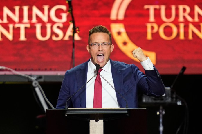 Benny Johnson speaks at a memorial for conservative activist Charlie Kirk, Sunday, Sept. 21, 2025, at State Farm Stadium in Glendale, Ariz.