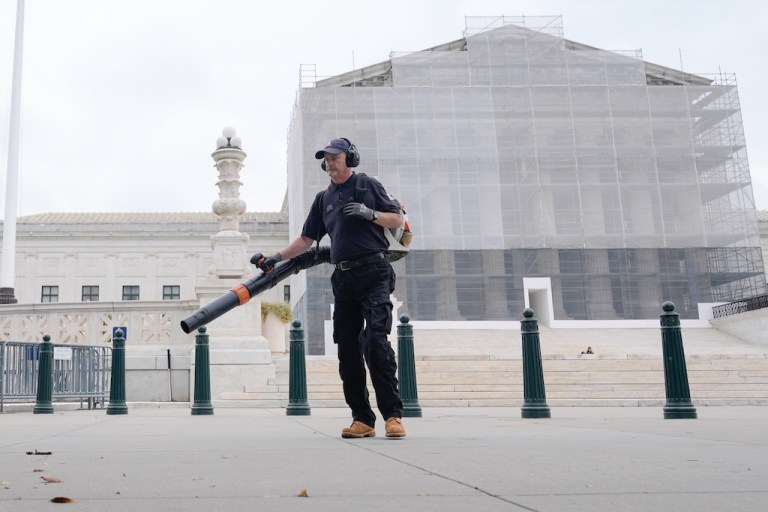 A Capitol service worker cleans outside of the Supreme Court, Thursday, Sept. 25, 2025, in Washington. (AP Photo/Mariam Zuhaib)