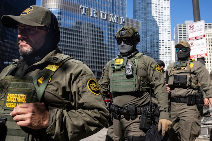 Federal agents from U.S. Immigration and Customs Enforcement and U.S. Customs and Border Protection walk along West Wacker Drive in the Loop, Sunday, Sept. 28, 2025, in Chicago. (Ashlee Rezin/Chicago Sun-Times via AP)