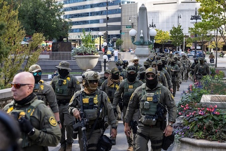Federal agents from Immigration and Customs Enforcement and U.S. Customs and Border Protection walk along West Wacker Drive in Chicago
