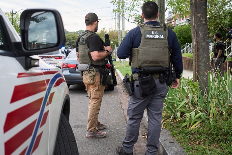 Armed U.S. Marshalls join Bureau of Alcohol, Tobacco, Firearms and Explosives Police (ATF), and Metropolitan Police, during an operation for a judicial warrant for a DUI in which one person was arrested, Monday, Sept. 29, 2025, in a residential neighborhood in northwest Washington.