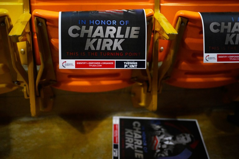 Signs for Charlie Kirk hang from seats at a Turning Point USA rally at Utah State University, as a part of the organization's push to memorialize Kirk, Tuesday, Sept. 30, 2025, in Logan, Utah. (AP Photo/Alex Goodlett)
