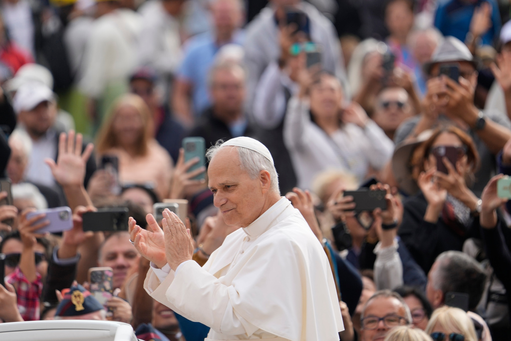 Pope Leo XIV applauds as he arrives for his weekly general audience in St. Peter's Square.