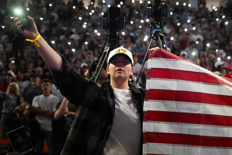 An attendee holds an American flag during a Turning Point USA rally.