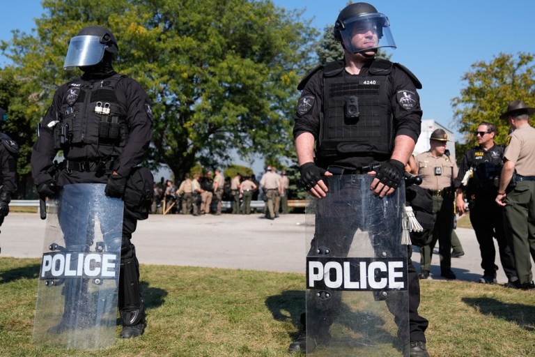 Law enforcement hold back protesters near an Immigration and Customs Enforcement facility in Broadview, Ill., Friday, Oct. 3, 2025. (AP Photo/Erin Hooley)