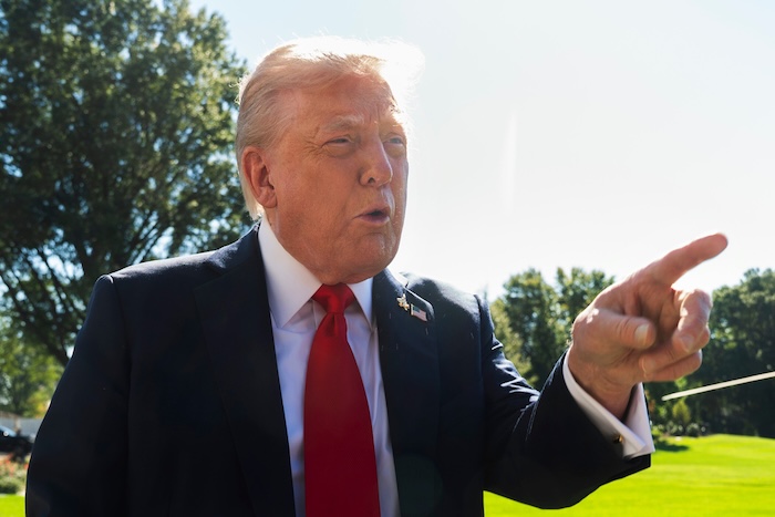 President Donald Trump speaks to reporters before departing the White House, en route Norfolk, Va., to observe a naval sea power demonstration, Sunday, Oct. 5, 2025, in Washington. (AP Photo/Manuel Balce Ceneta)