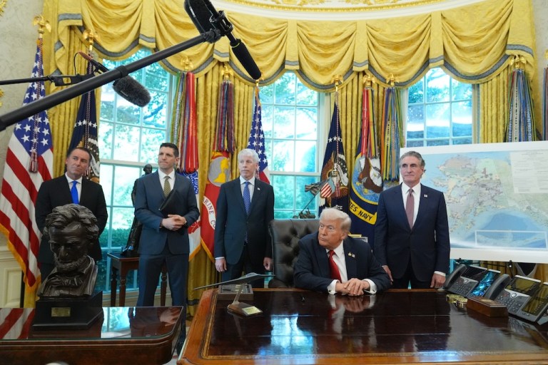 President Donald Trump speaks to reporters in the Oval Office.