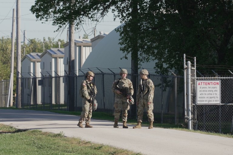 Military personnel in uniform, with the Texas National Guard patch on, are seen at the U.S. Army Reserve Center, Wednesday, Oct. 8, 2025, in Elwood, Ill., a suburb of Chicago. (AP Photo/Laura Bargfeld)