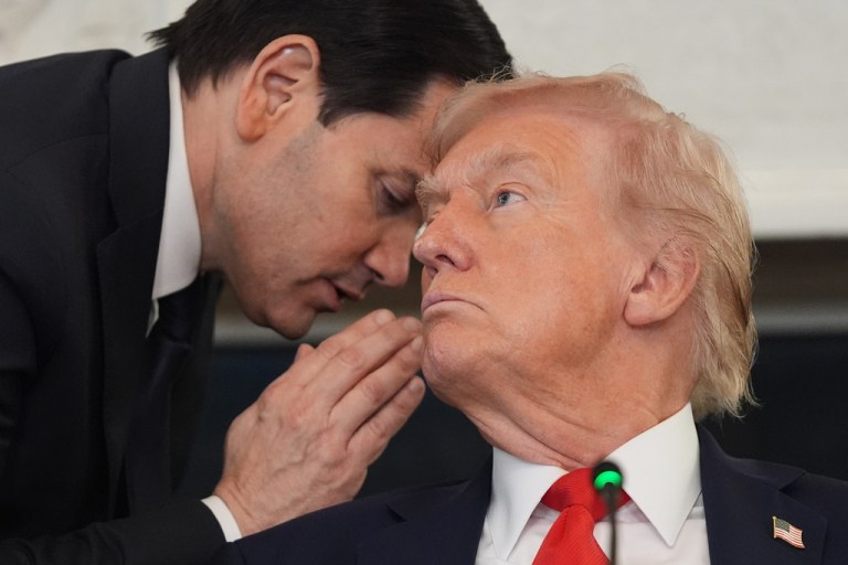 Secretary of State Marco Rubio whispers to President Donald Trump during a roundtable meeting on antifa in the State Dining Room at the White House, Wednesday, Oct. 8, 2025, in Washington. (AP Photo/Evan Vucci)