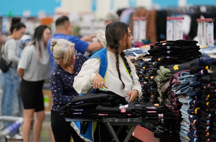 A worker stocks a display of clothing at a Sam's Club, Wednesday, Sept. 24, 2025, in Bentonville, Ark.