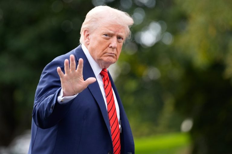 President Donald Trump walks on the South Lawn after arriving on Marine One.