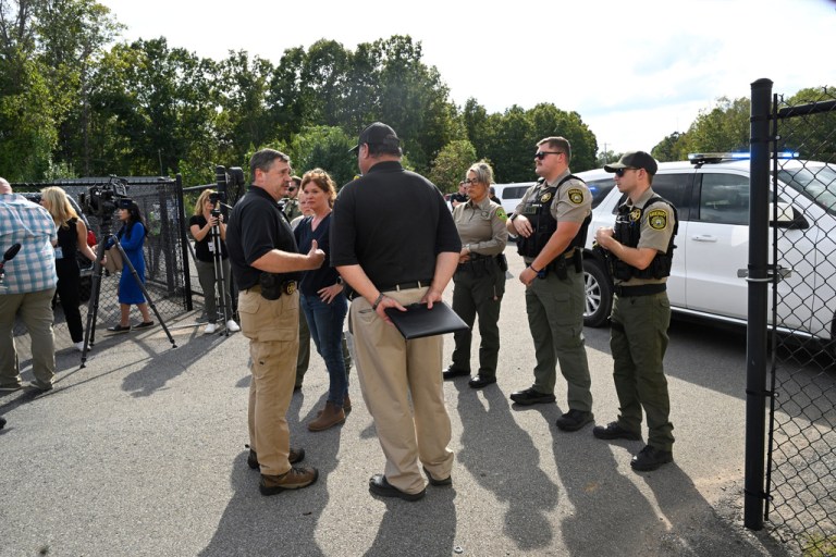 Hickman County Sheriff J. Craft , left, and Humphreys County Sheriff Chris Davis gather after delivering a news conference as deputies block the entrance to Accurate Energetic Systems plant that stores explosives, after a blast resulted in multiple fatalities and others missing at Accurate Energetic Systems, Friday, Oct. 10, 2025, in Bucksnort, Tenn. (AP Photo/John Amis)
