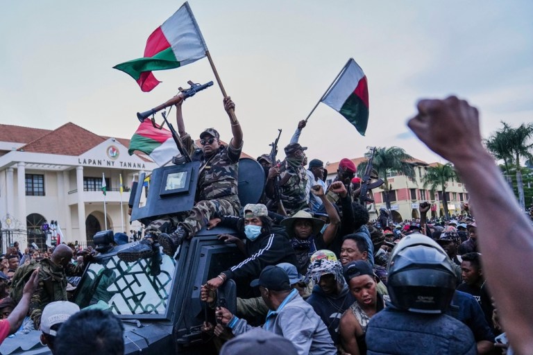 Soldiers are greeted by people gathering for a ceremony in tribute to demonstrators killed during recent anti-government protest in Antananarivo, Madagascar, Sunday, Oct. 12, 2025.