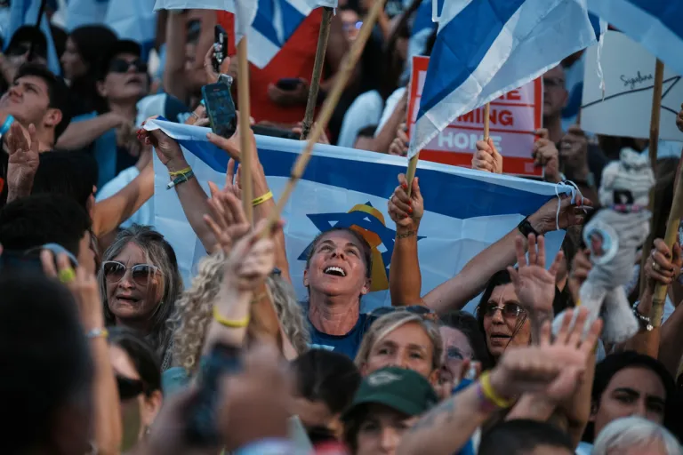People react as they gather to watch a live broadcast of Israeli hostages released from Gaza.