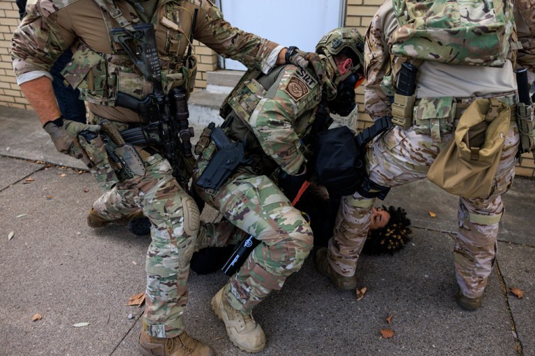 Federal officers detain a protester in Chicago.