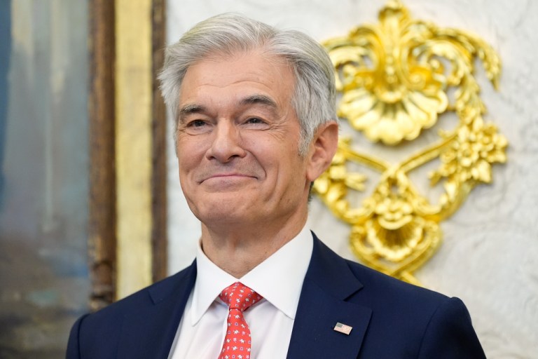 Centers for Medicare & Medicaid Services administrator Dr. Mehmet Oz listens as President Donald Trump speaks in the Oval Office of the White House, Thursday, Oct. 16, 2025, in Washington. (AP Photo/Alex Brandon)