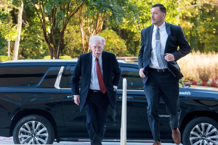 Former Trump administration national security adviser John Bolton, left, arrives for his arraignment at the Greenbelt Federal Courthouse in Greenbelt, Md., Friday, Oct. 17, 2025.