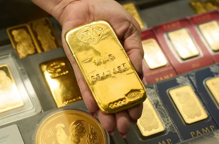 FILE - Sam Nguyen shows a gold bar at her shop in the St. Vincent Jewelry Center in the Jewelry District of Los Angeles, Wednesday, April 30, 2025.