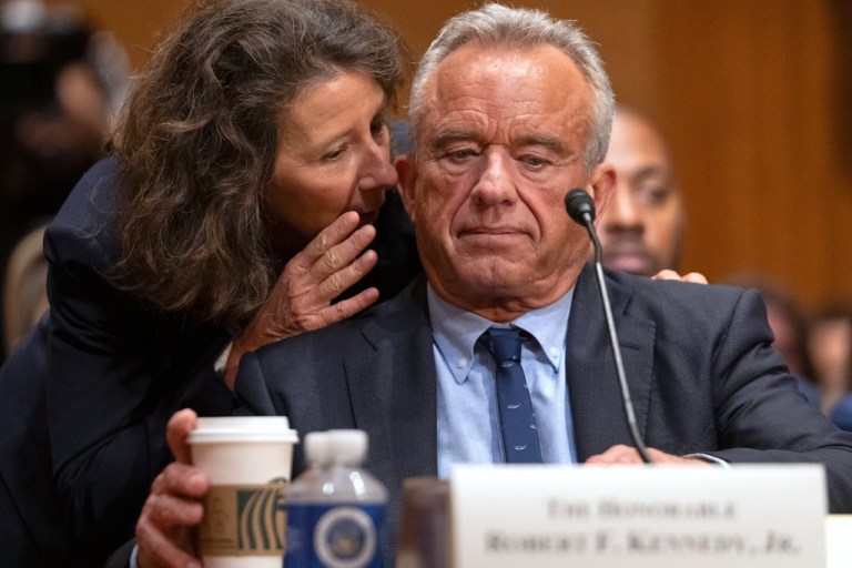 Secretary of Health and Human Services Robert F. Kennedy Jr. listens to deputy chief of staff Stefanie Spear.