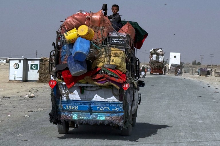 Vehicles carry Afghan refugee families and their belongings moving towards a border crossing point which partially opens following Pakistan Afghanistan ceasefire truce, on the outskirts of Chaman, a border town on the Pakistan Afghan border, Sunday, Oct. 19, 2025.