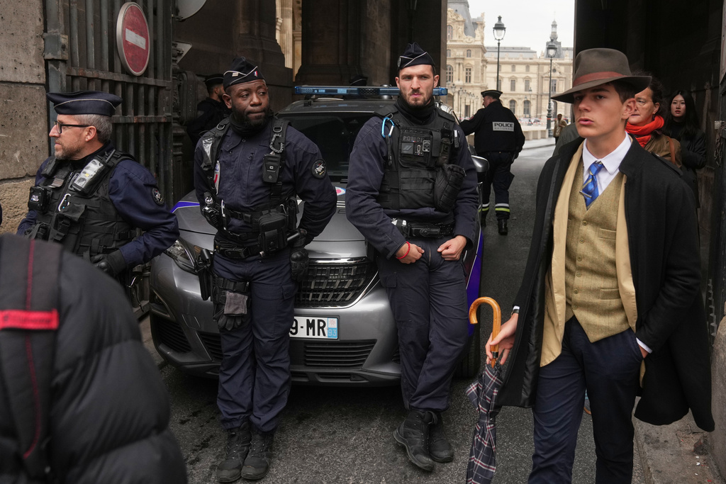 Inspector Clouseau? The mystery man in an AP photo after the Louvre jewel heist creates a buzz
