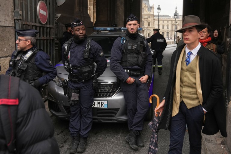 Police officers block an access to the Louvre museum after a robbery Sunday, Oct. 19, 2025, in Paris.
