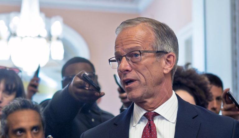 Senate Majority Leader John Thune, R-S.D., pauses in his office doorway to speak to reporters on day 20 of the government shutdown, at the Capitol in Washington, Monday, Oct. 20, 2025.