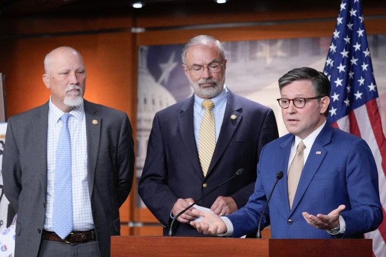 Speaker of the House Mike Johnson speaks as Rep. Andy Harris and Rep. Chip Roy listen during a news conference.
