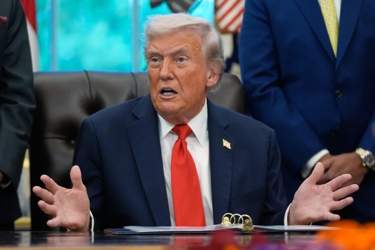 President Donald Trump answers questions from reporters during a Diwali celebration in the Oval Office.