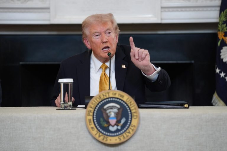 President Donald Trump answers questions from reporters.