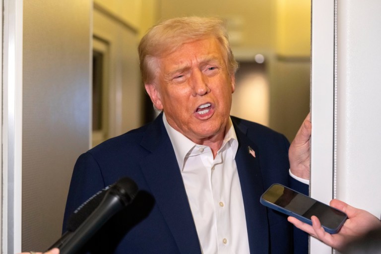 President Donald Trump speaks to reporters aboard Air Force One en route to Asia, Friday, Oct. 24, 2025. (AP Photo/Mark Schiefelbein)